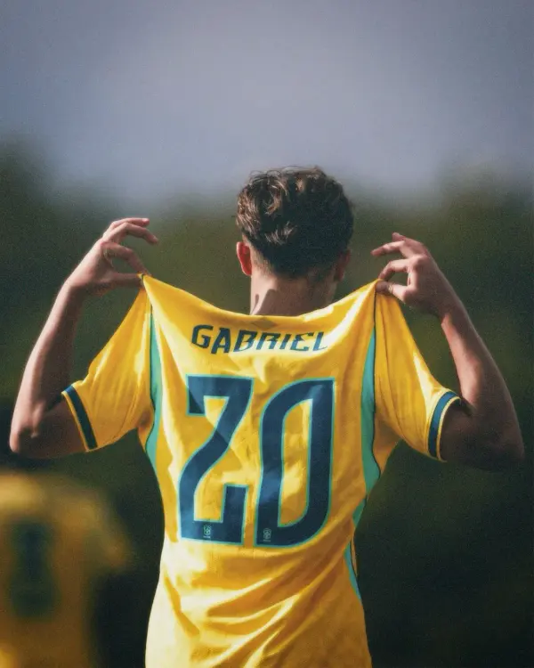 Atleta de costas, vestindo a camisa amarela número 20 com o nome Gabriel.